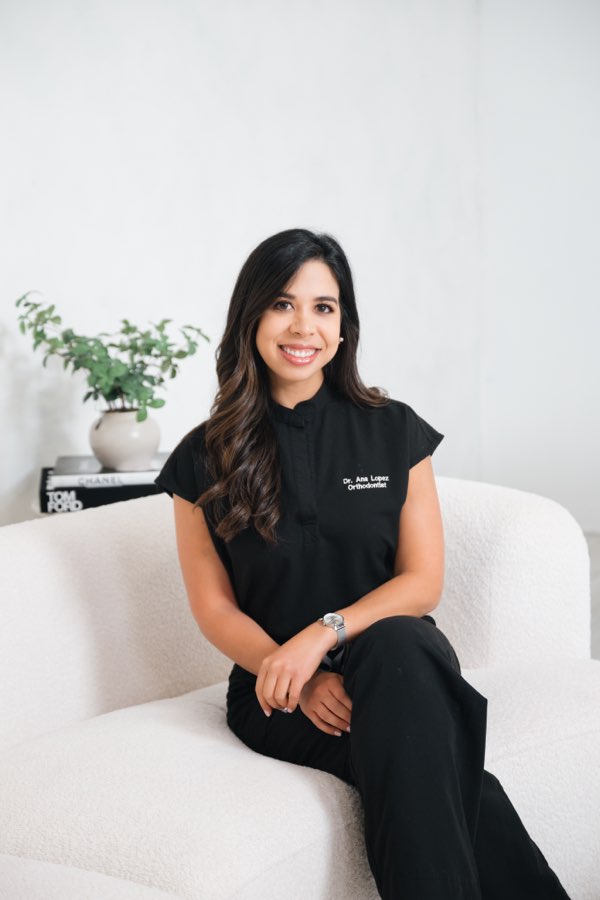 Dr. Lopez seated in the Lumiere Orthodontics reception area